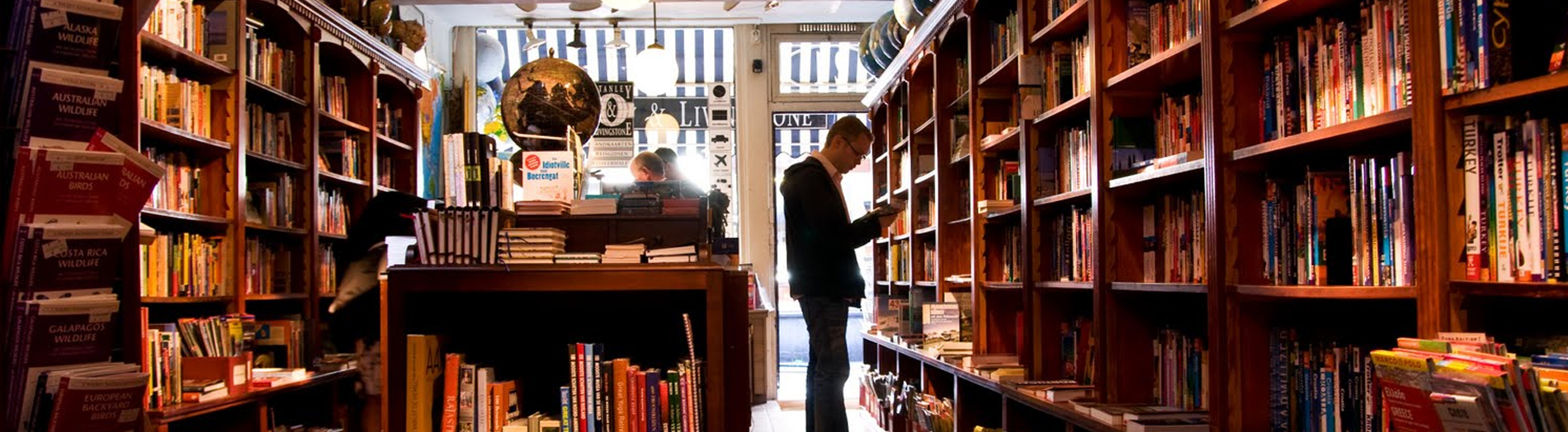 Man reading book inside of the book shoppe
